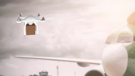 drone carrying a box beside an airplane