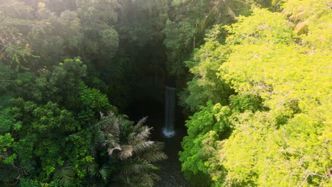 wonderful waterfall in tropical rain forest in bali, tibumana waterfall