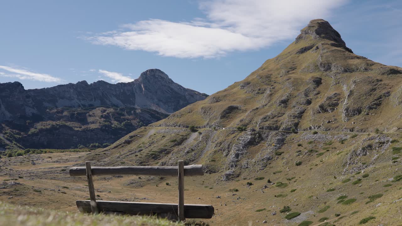 Rustic wooden bench viewpoint looking at Stožina peak in Montenegro