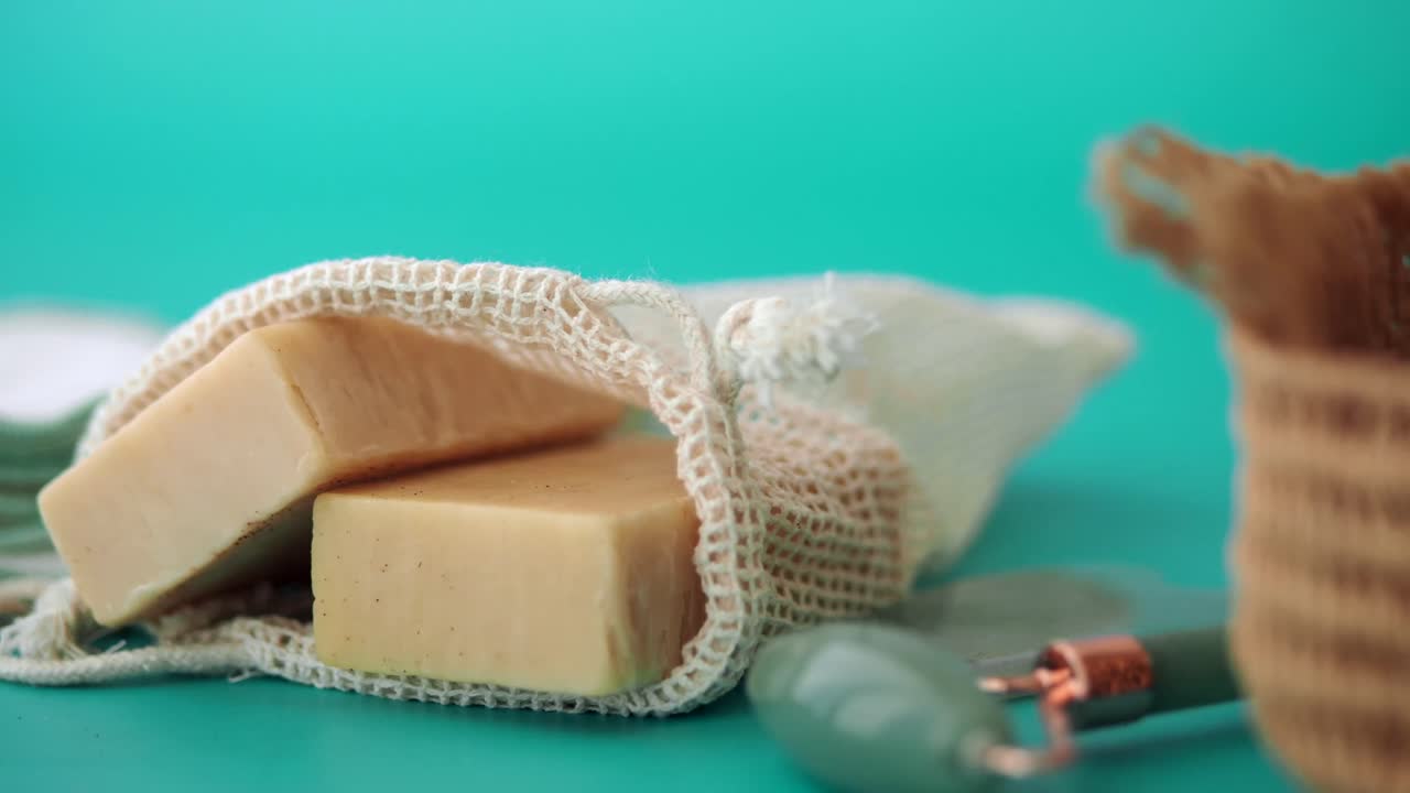 Soap and skincare products on turquoise background