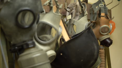 old vintage gas masks hanging on a wall