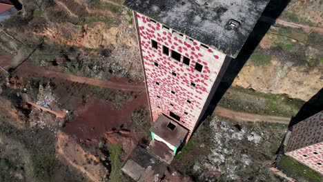 painted abandoned high tower of old factory near ruined mine station in perrenjas, albania