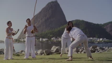 capoeira training session by the water in rio de janeiro