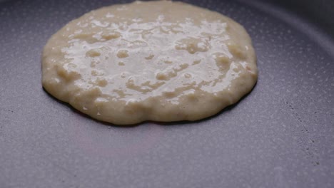 close-up of pouring pancake batter on a hot pan