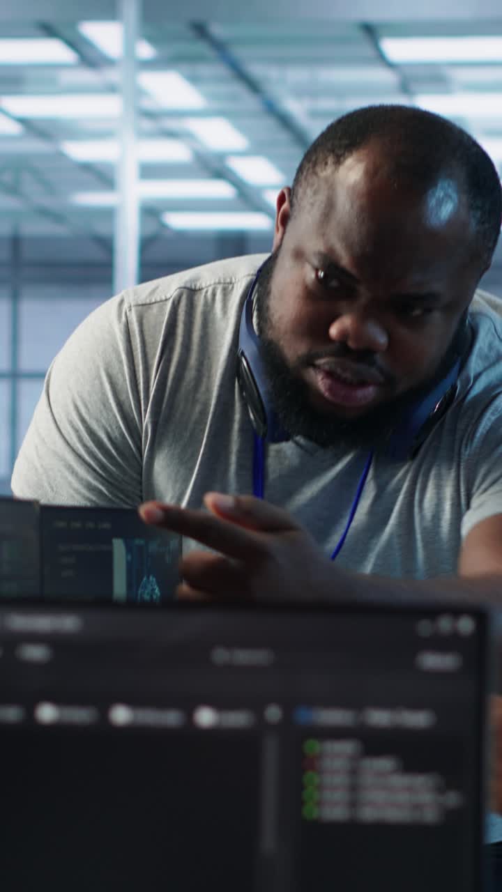 African American Programmer Discussing Code on Computer Screen