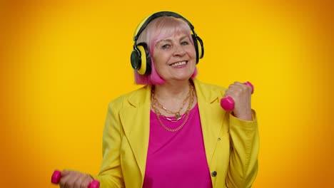 Senior-granny-woman-listening-music-via-headphones,-working-out,-lifting-pink-dumbbells,-healthcare