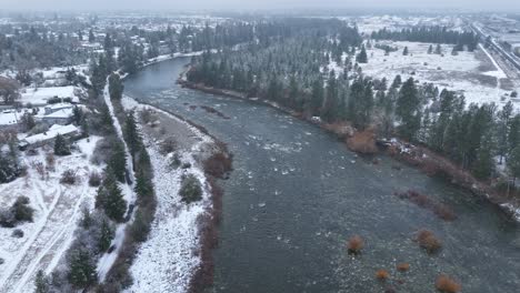 drone shot of the spokane river with snow covering the ground