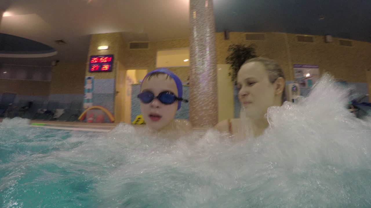 Barn bader med mor og får hydromassage