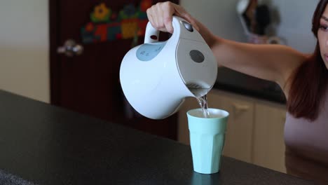 sequence of pouring a drink from a kettle into a cup