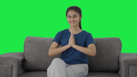 happy indian teenage girl doing namaste green screen