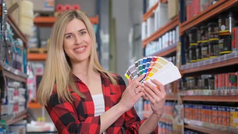 Woman Choosing Paint Colors in a Home Improvement Store