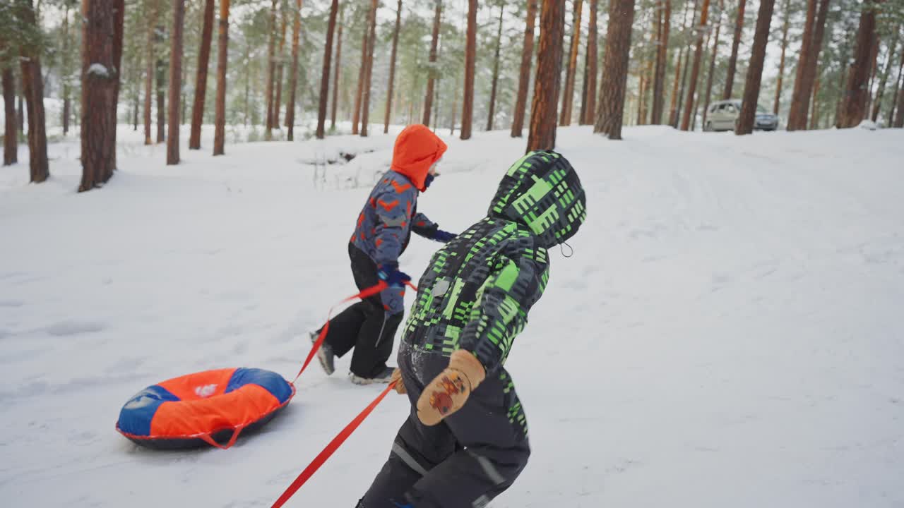 Kids Snow Tubing in the Forest
