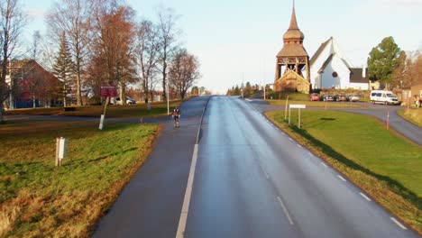 man skiing down lonely rural road near small town ostersund, sweden