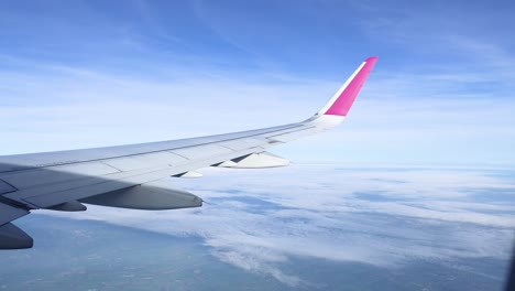 airplane wing over clouds and krabi landscape