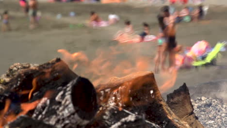 slow motion of couple kissing and hugging firewood burning by the beach