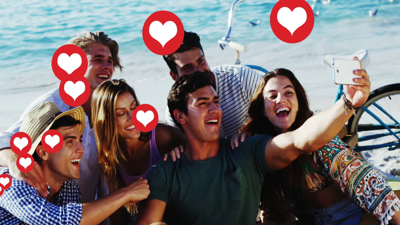 múltiples iconos de corazón flotando contra un grupo de amigos tomando una selfie