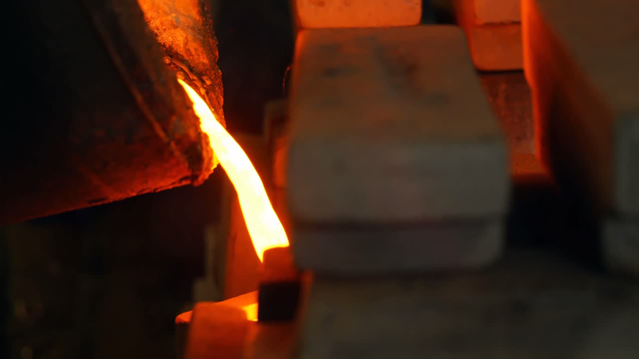Molten metal being poured in mold at foundry workshop 4k