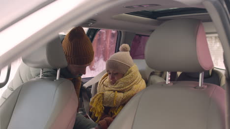 girl sitting in the back seat of a car