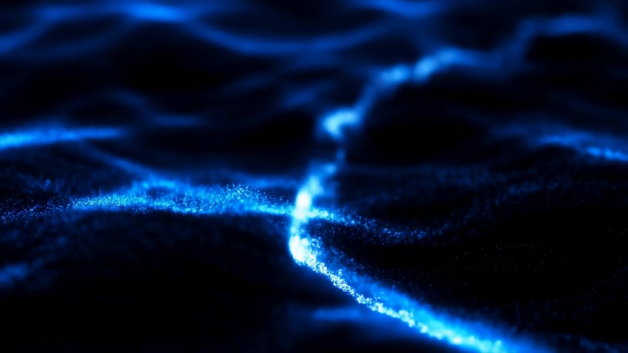 Glowing blue particle stream flowing over rippled dark granular surface mid-sequence