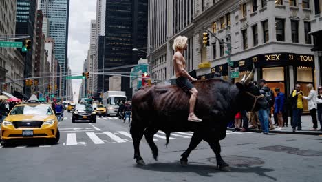 man riding a bull in nyc