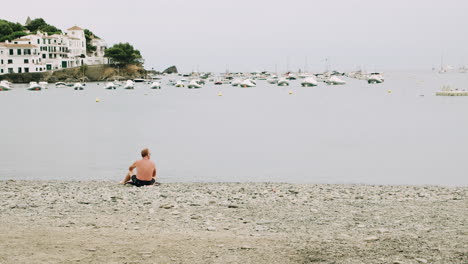 man relaxing on an empty beach