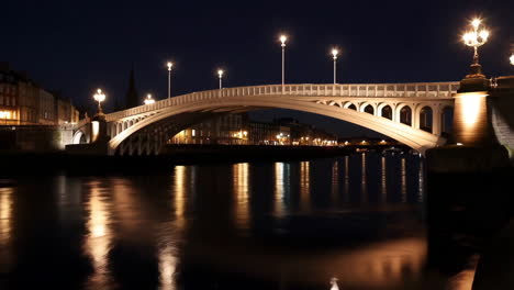 illuminated bridge and river at night