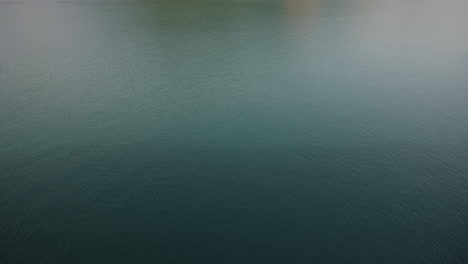 Slow-motion-revealing-shot-of-beautiful-New-Zealand-countryside-lake-and-hillside