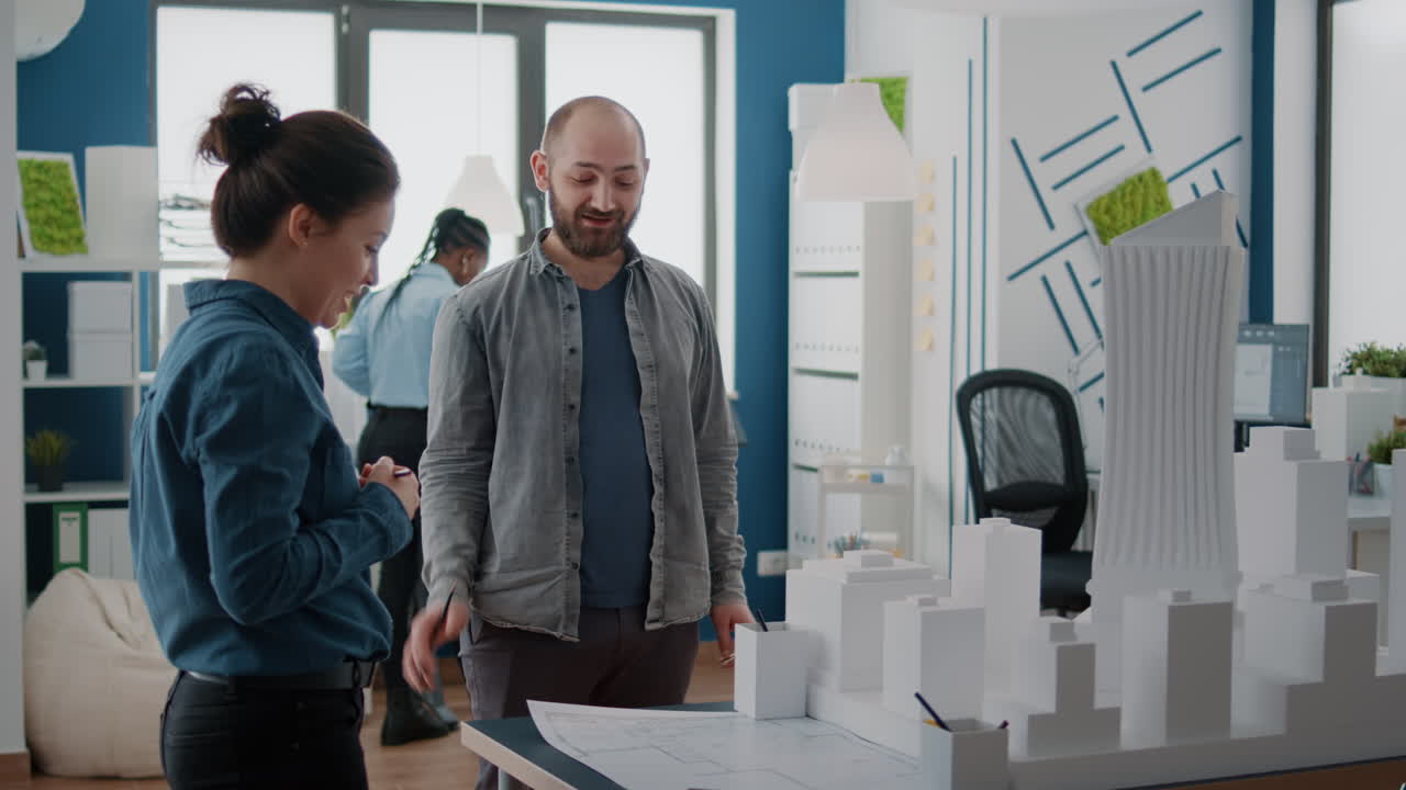 Architects working on building model