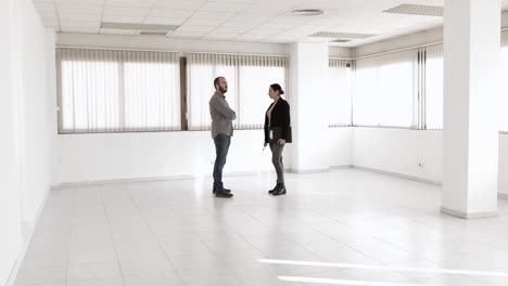 man discussing with a real estate agent while visiting a new office space