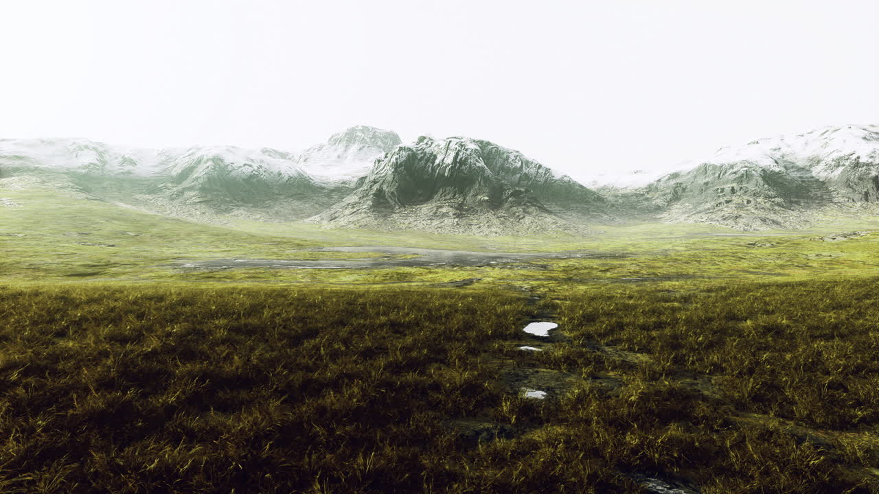 Majestic mountain landscape with grass and snow during a cloudy day
