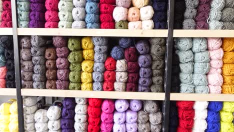 colorful yarn balls on shelves in a craft store