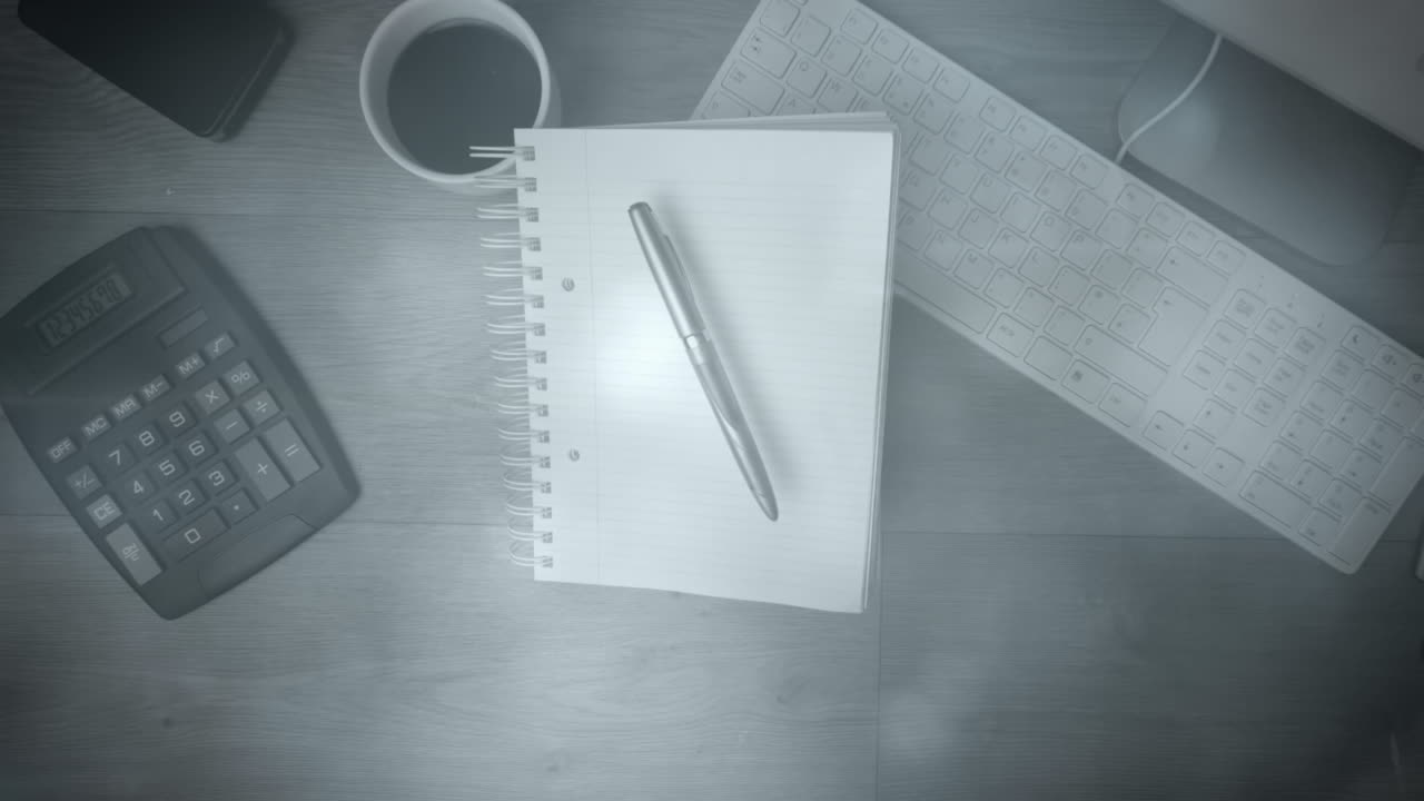 Animation of lights over notepad, calculator and keyboard on desk