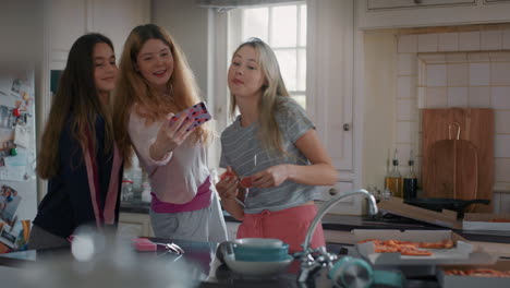 happy teenage girls taking photo using smartphone posing making faces enjoying hanging out together sharing friendship on social media