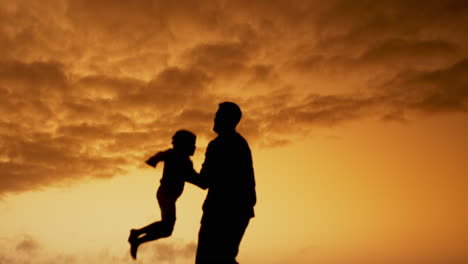 father and child at sunset