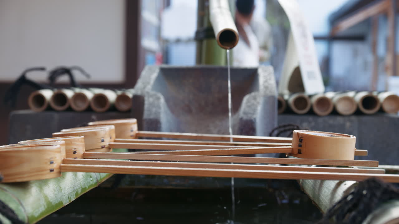 Close up of a purification water fountain at the Yasaka shrine in daylight in Kyoto, Japan