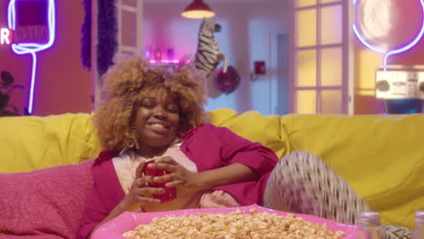 woman relaxing with popcorn on the couch