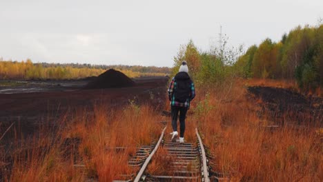 a desperate woman walks along a peat bog