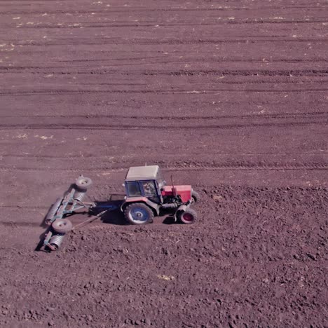 aerial view of tractor tilling farmland