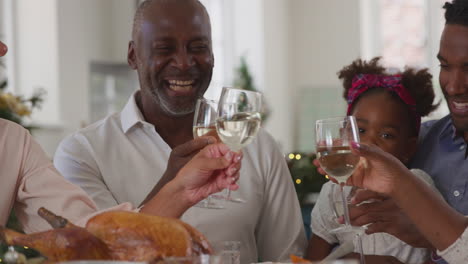 Multi-Generation-Family-Celebrating-Christmas-At-Home-Eating-Meal-Together