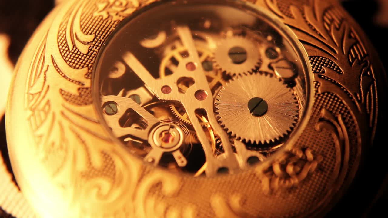 Close-Up of Intricate Golden Pocket Watch Mechanism with Moving Gears