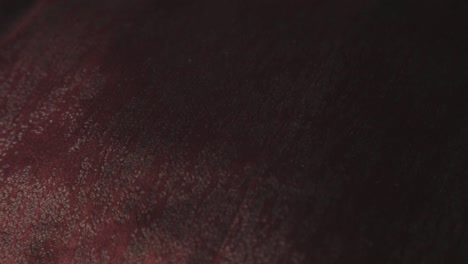 closeup view of the fabric texture of a brown suit in the dark room - closeup shot