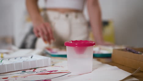 young woman painting with aquarelle