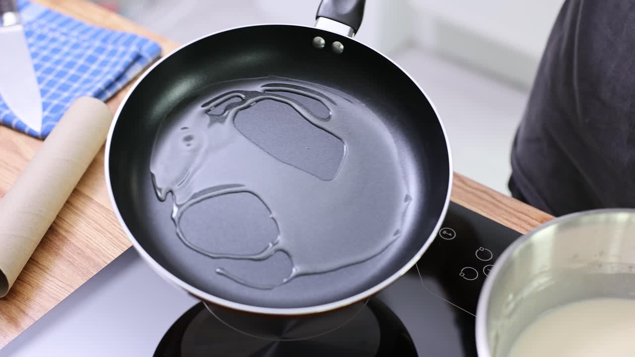Preparing food in a frying pan on a stove
