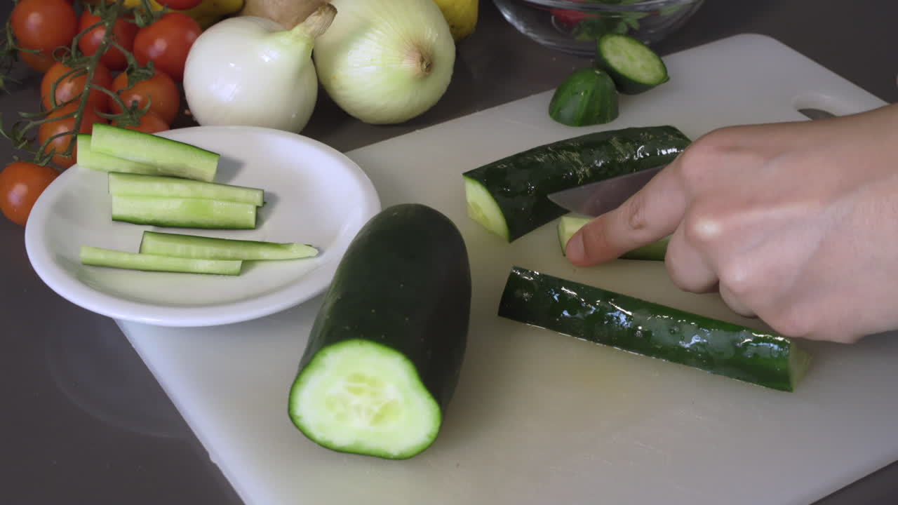 Cutting Nutritious Green Cucumber Into Strips - closeup shot