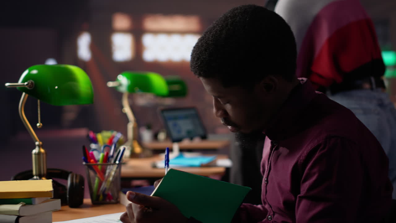 Vertical video african american guy studies for a critical law exam and reading specialty books