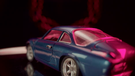 blue model car with magenta lighting