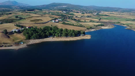 beautiful riverside camping park in montalegre, portugal - drone aerial shot over rabagão river in the afternoon