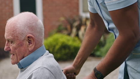 nurse assisting senior man in wheelchair