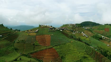 4K-Cinematic-nature-aerial-footage-of-a-drone-flying-over-the-beautiful-mountains-of-Mon-Jam-next-to-Chiang-Mai,-Thailand-on-a-sunny-day