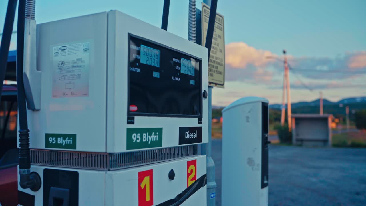 Gas Pump At Sunset In Norway, Labeled With 95 Blyfri And Diesel, With Nozzles And Digital Display. closeup shot
